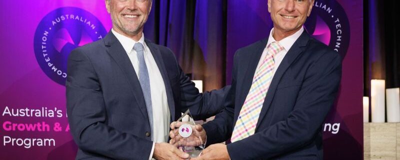 Norman accepting award at Australian Technologies Competition